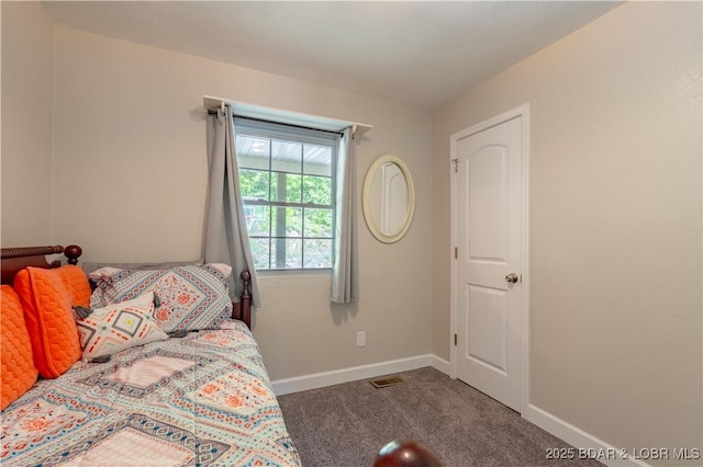 bedroom featuring carpet and baseboards