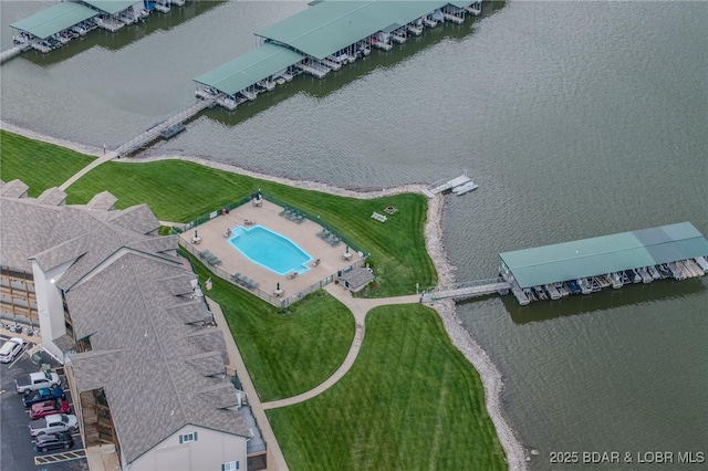 drone / aerial view of a large body of water and a pool
