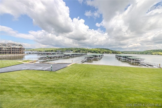 dock area featuring a yard and a water view