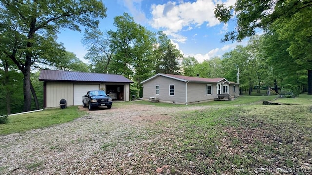 29745 Canary Rd, Gravois Mills, MO 65037 - rear view of property with an outdoor structure, a garage, a yard, and driveway