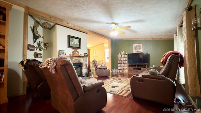 29745 Canary Rd, Gravois Mills, MO 65037 - living room with a textured ceiling, wood finished floors, a ceiling fan, and a fireplace