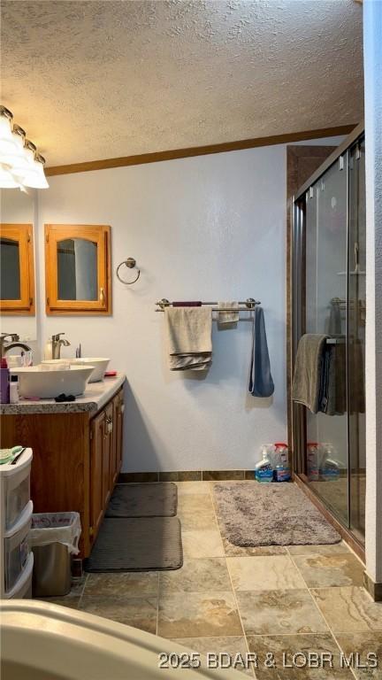 29745 Canary Rd, Gravois Mills, MO 65037 - full bathroom with a textured ceiling, a shower stall, ornamental molding, vanity, and baseboards