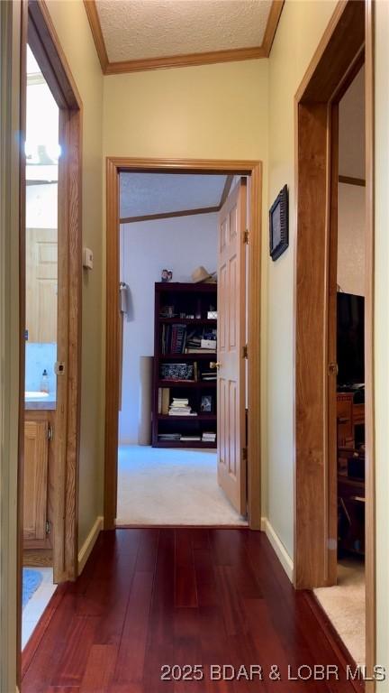 29745 Canary Rd, Gravois Mills, MO 65037 - hall featuring dark wood-type flooring, crown molding, and baseboards