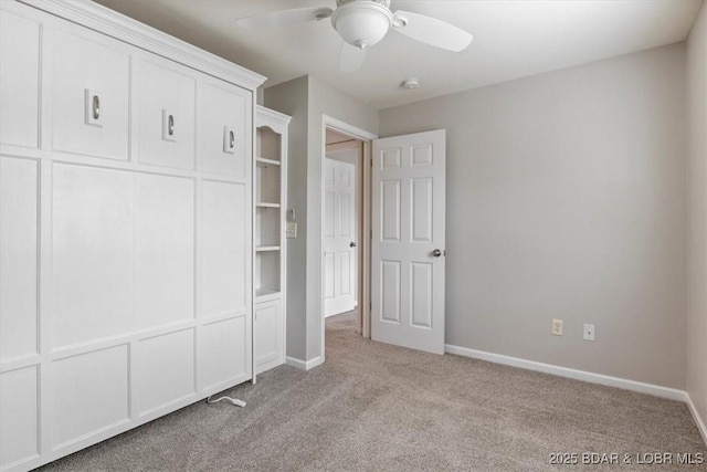 unfurnished bedroom with carpet, baseboards, and ceiling fan