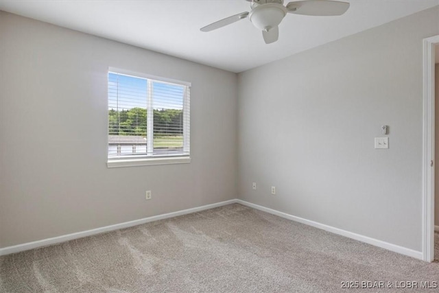 empty room with carpet floors, ceiling fan, and baseboards