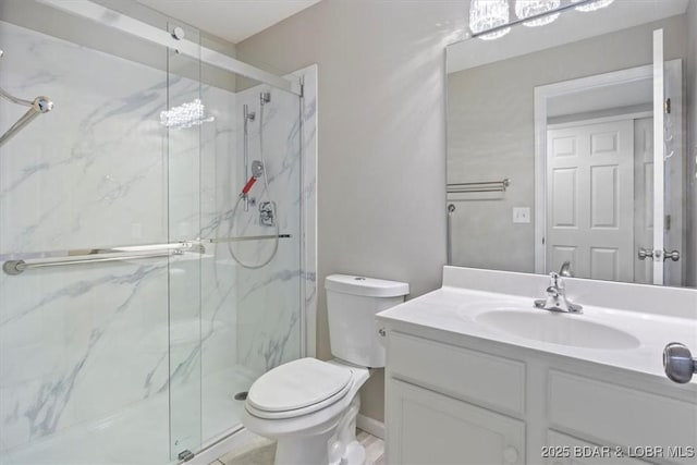 bathroom with a marble finish shower, toilet, and vanity