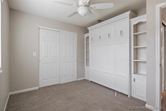 unfurnished bedroom with carpet floors, baseboards, and ceiling fan