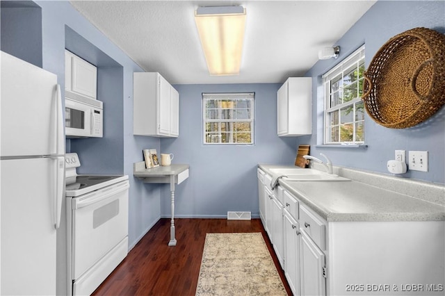 35 Teak Village Dr, Lake Ozark, MO 65049 - kitchen with white appliances, dark wood finished floors, a sink, white cabinetry, and light countertops