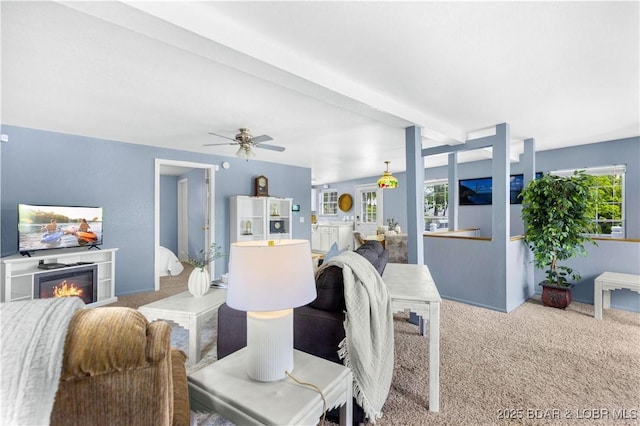 35 Teak Village Dr, Lake Ozark, MO 65049 - carpeted living area featuring ceiling fan and a glass covered fireplace