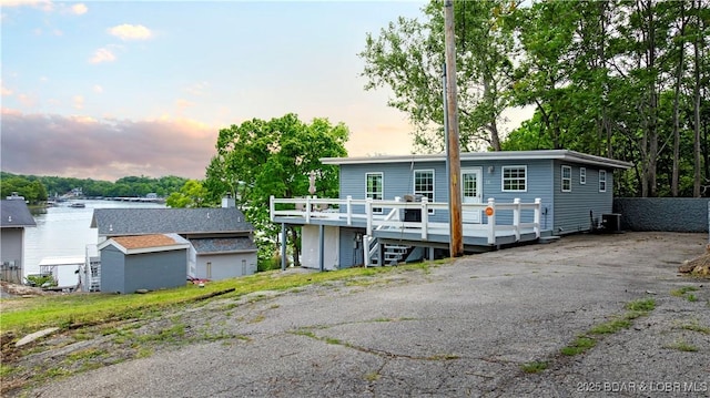 35 Teak Village Dr, Lake Ozark, MO 65049 - view of front of home featuring a wooden deck and central AC