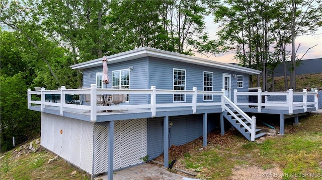 35 Teak Village Dr, Lake Ozark, MO 65049 - back of house at dusk with a wooden deck