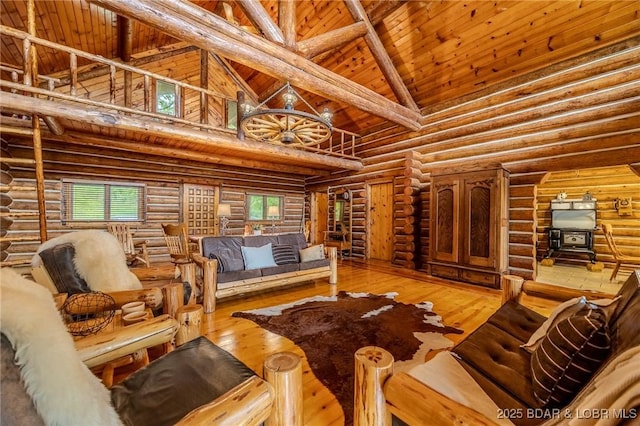 54 Scenic Shores Ln, Climax Springs, MO 65324 - living room featuring high vaulted ceiling, a wood stove, log walls, healthy amount of natural light, and wooden ceiling with exposed beams
