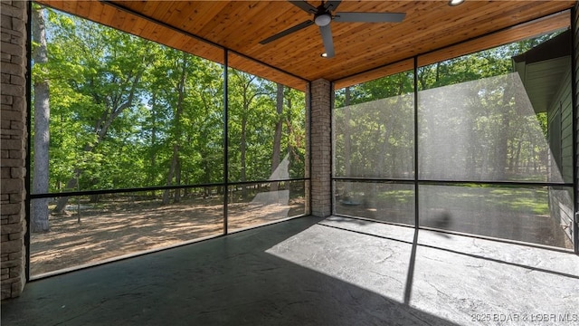 unfurnished sunroom featuring a ceiling fan
