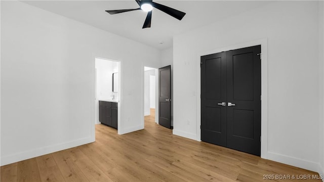 unfurnished bedroom featuring baseboards, light wood-style flooring, a closet, and a ceiling fan