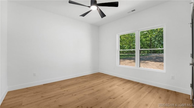 unfurnished room featuring baseboards, light wood finished floors, and ceiling fan