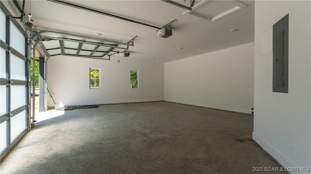 garage featuring a garage door opener, electric panel, and baseboards