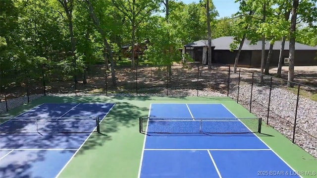 view of tennis court with fence