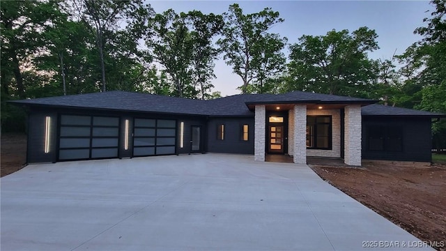prairie-style house with a garage and driveway