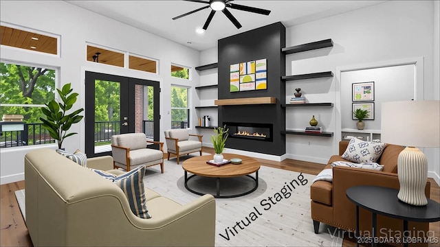 living area with ceiling fan, built in shelves, wood finished floors, and a glass covered fireplace