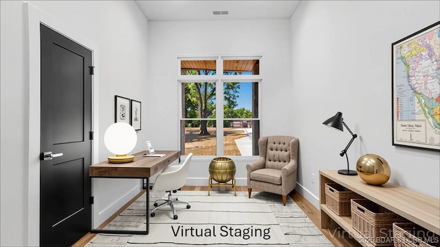office area featuring baseboards and wood finished floors
