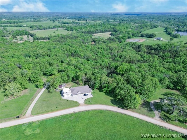 aerial overview of property's location with a heavily wooded area