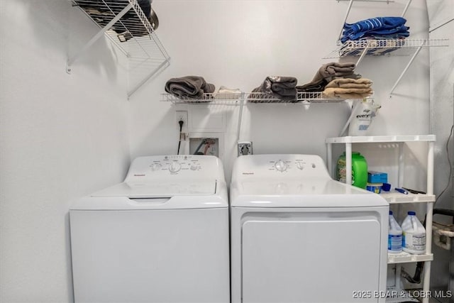 clothes washing area featuring washing machine and clothes dryer