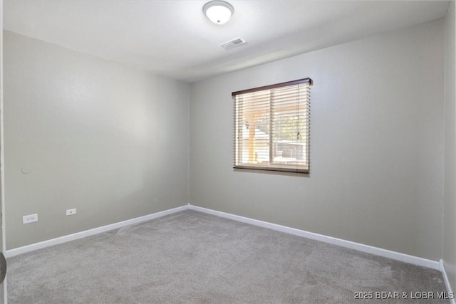 carpeted empty room with baseboards