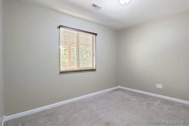 carpeted empty room with baseboards