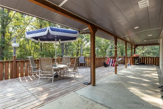 wooden terrace featuring outdoor dining area