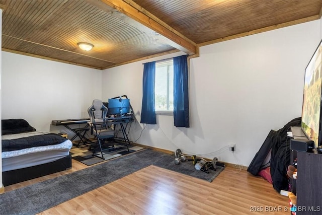 bedroom featuring wood ceiling, wood finished floors, an office area, and baseboards