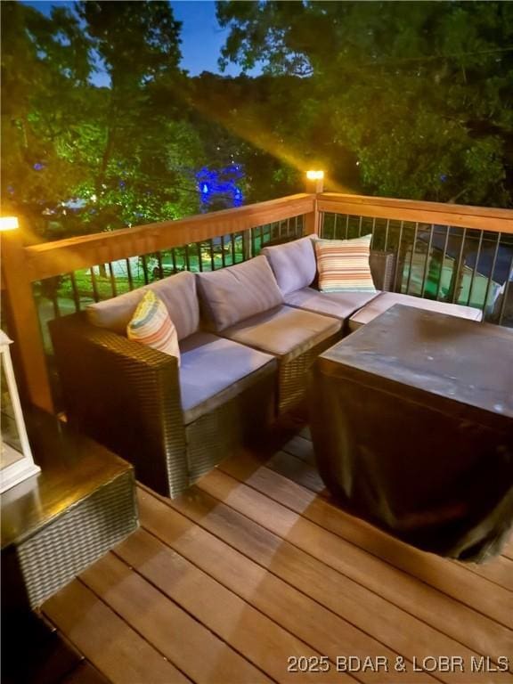wooden terrace with an outdoor hangout area