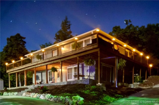 view of back of house at night