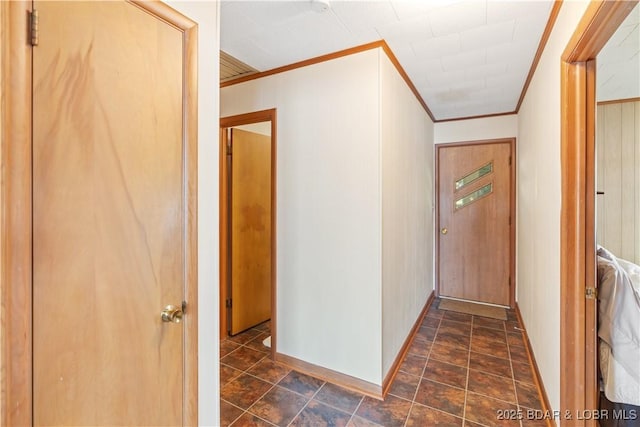 hall featuring crown molding and baseboards