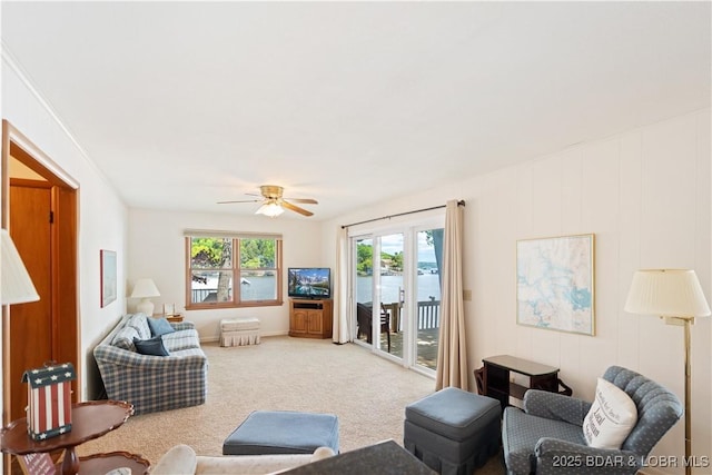carpeted living room featuring a ceiling fan