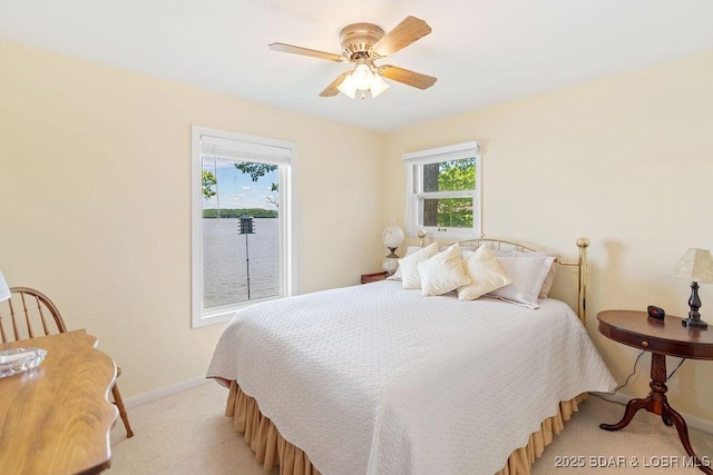 bedroom with light carpet, baseboards, and ceiling fan