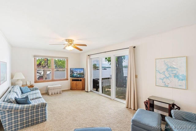 living room with plenty of natural light, ceiling fan, and carpet floors