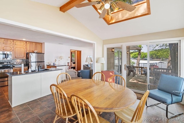 dining room featuring a ceiling fan, beamed ceiling, and high vaulted ceiling