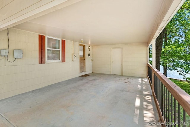 view of patio / terrace featuring an attached carport and a balcony