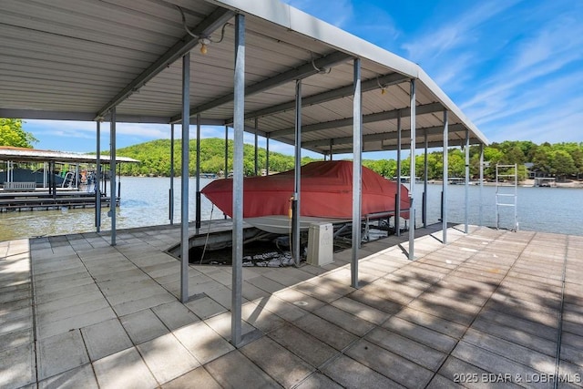 dock area with boat lift and a water view