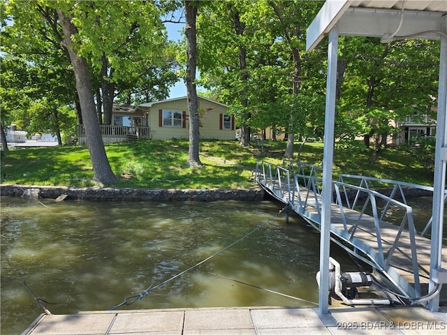 dock area featuring a water view and a lawn