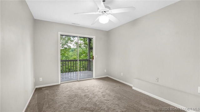 spare room with carpet flooring, baseboards, and ceiling fan