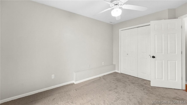 unfurnished bedroom featuring carpet flooring, baseboards, a closet, and ceiling fan