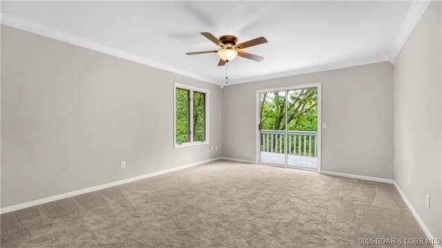 empty room featuring crown molding, a ceiling fan, baseboards, and carpet flooring