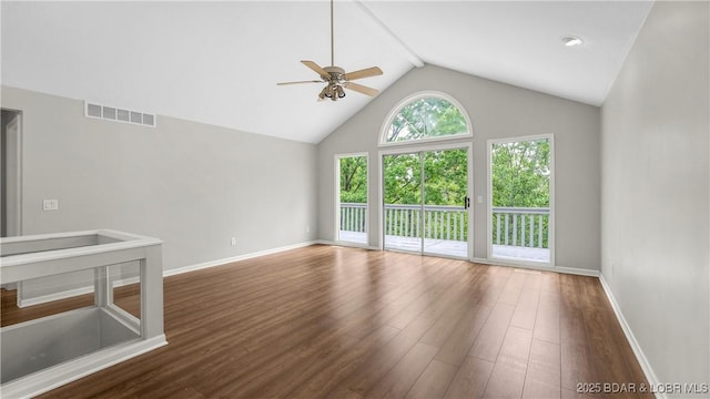unfurnished living room with ceiling fan, wood finished floors, baseboards, high vaulted ceiling, and beamed ceiling