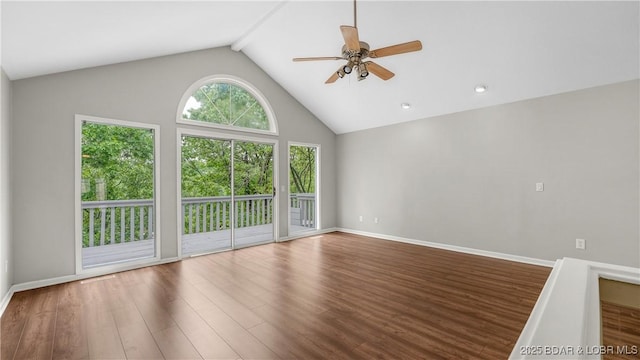 unfurnished living room with ceiling fan, wood finished floors, baseboards, and high vaulted ceiling