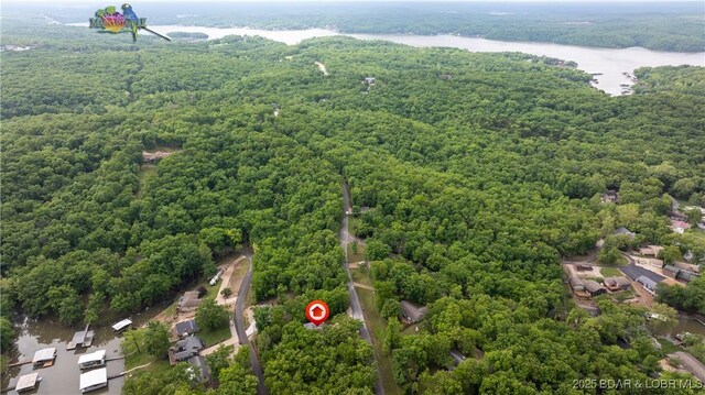 bird's eye view of a heavily wooded area and a nearby body of water