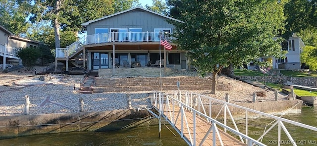 50 Shannon Cir, Sunrise Beach, MO 65079 - rear view of property featuring stairs, board and batten siding, and a deck with water view