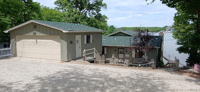 50 Shannon Cir, Sunrise Beach, MO 65079 - view of front of house featuring a detached garage, board and batten siding, and roof with shingles