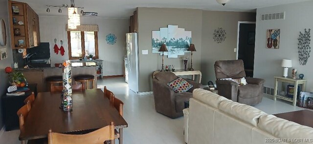 50 Shannon Cir, Sunrise Beach, MO 65079 - living room with a ceiling fan, concrete flooring, and baseboards