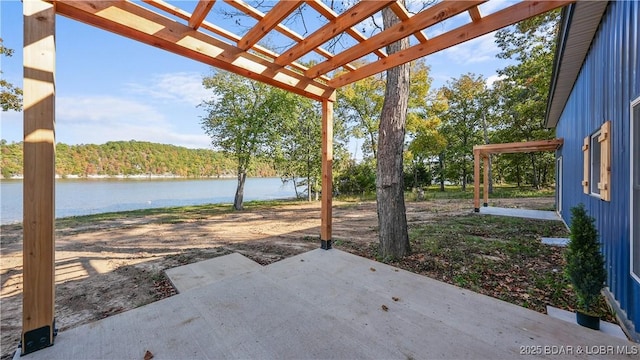 view of patio with a water view and a pergola